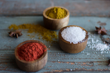 Spices. Herbs. Curry, salt, pepper Saffron, turmeric, tandori masala and other on a wooden rustic background.Large collection of different spices and herbs.