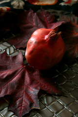 Ripe pomegranate on a background of leaves..