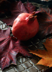 Ripe pomegranate on a background of leaves..