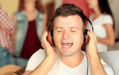 Handsome man listening to music at home