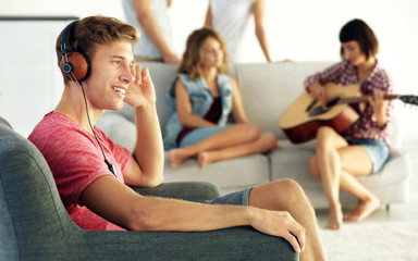 Handsome man listening to music at home