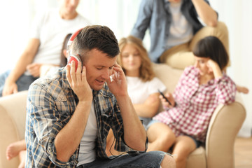 Handsome man listening to music at home