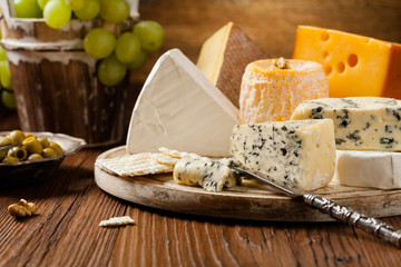 Mix cheese on wooden board.