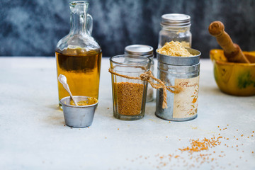 Mustard sauce glass jars with seeds and flour.   