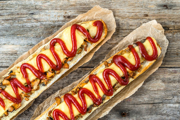 Crispy sandwich with cheese and mushrooms, open faced baguette 