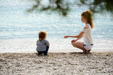 Fototapeta na wymiar Mother and son on beach