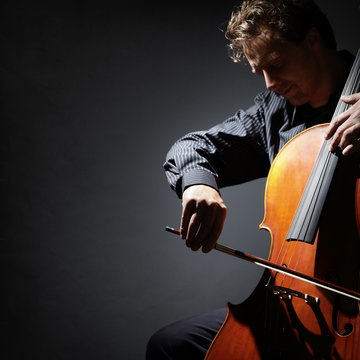 Cello player or cellist performing