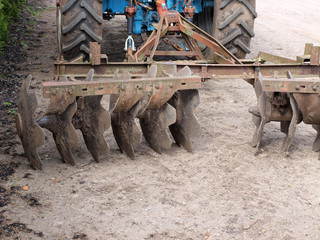 Tractor powered heavy disc harrows on ground back view