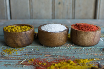 spices. Herbs. Curry, salt, pepper Saffron, turmeric, tandori masala and other on a wooden rustic background.Large collection of different spices and herbs.