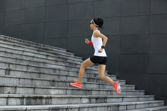 fitness sport woman running upstairs on city stairs