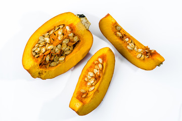 Sliced pumpkin on white, isolated slices with seeds, overhead