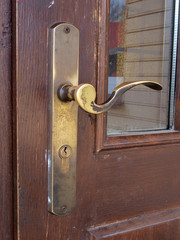 Brown wooden doors with old copper handle      