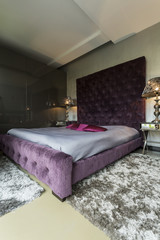 Big bed with violet pillows