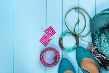 Set of fashionable women's acsessories on blue wooden background