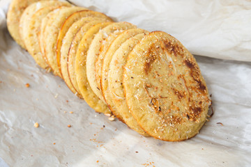 traditional Myanmar dessert fried and baked from the dough, sprinkle with coconut, nuts, sesame