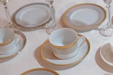 Fototapeta na wymiar Brautiful white tea crockery stand on a white tablecloth
