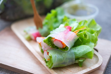Vegetable salad roll on wood tray. Selective focus