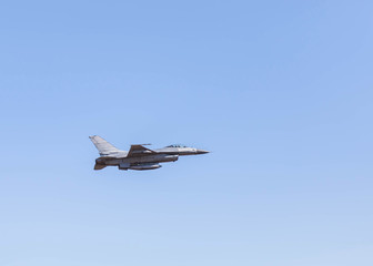 f16 falcon fighter jet military aircraft flying on blue sky background 