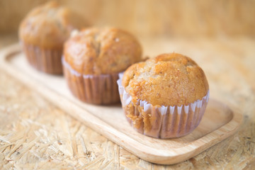 Fresh baked muffins from oven on wood tray