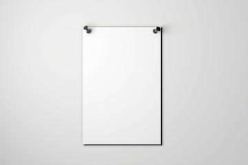 Blank white poster pinned to a plain wall with pushpins