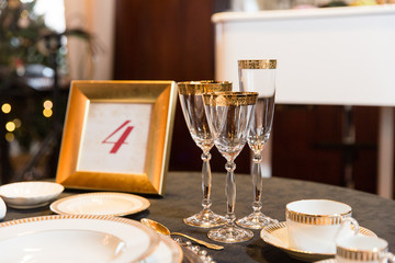 Crockery with golden design sparkle on the dinner table
