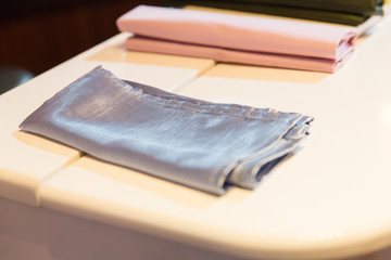 Silver napkin lies on the white tablecloth