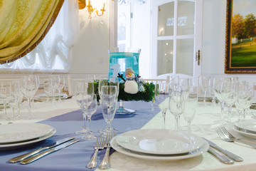Sparkling crockery stands on the dinner table decorated in winte