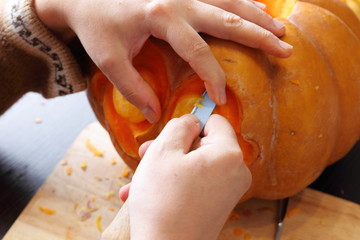 Carving out a pumpkin to prepare halloween lantern