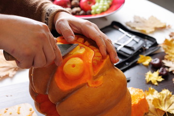 Carving out a pumpkin to prepare halloween lantern