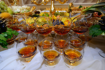 Glasses of cognac on dessert table