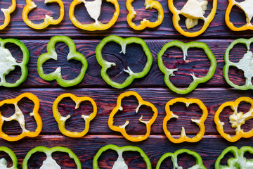 sliced fresh peppers on wooden background close-up