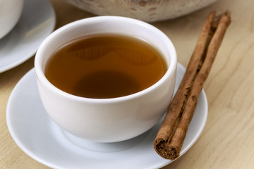 Chinese tea beside a cinnamon stick. Pu-erh tea