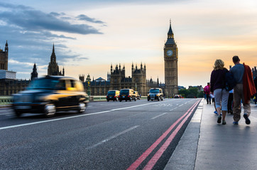 Fototapeta na wymiar Big Ben from Westminster Bridge with Traditional Taxis in Motion