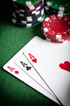 Playing cards and poker chips on green table