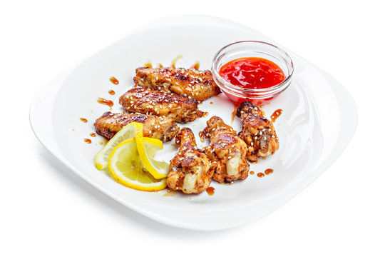 chicken wings on plate with sauce