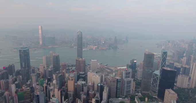 Aerial view of Hong Kong city at dusk, 4k footage. Flying over huge metropolis and high skyscrapers in the evening. 