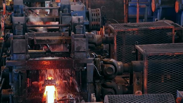 Ironworks plant. Working Machines. Borning Hot Beams. Closeup