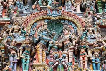 Madurai, India - October 19, 2013: Closeup of the wedding scene of Meenakshi and Shiva, while Vishnu gives his sister away. Facade of West Gopuram at Meenakshi Temple.