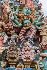 Madurai, India - October 19, 2013: Closeup of image representing the fierce goddess Kali also known as Durga. Facade of South Gopuram at Meenakshi Temple.
