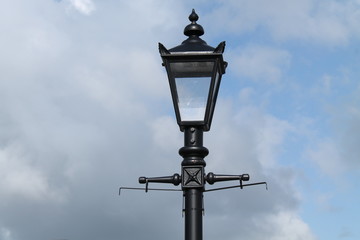 A Stylish Four Sided Metal and Glass Street Lamp.