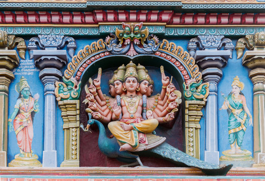 Madurai, India - October 19, 2013: Closeup of Lord Murugan. He sits on his mount the peacock and has multiple arms. Facade of Nagara Mandapam.