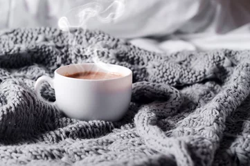 Tuinposter Having a cup of coffee in bed © YuliiaMazurkevych