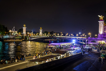 Fototapeta na wymiar Street on the waterfront of Paris by night in summer