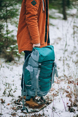 traveler with backpack in the winter forest