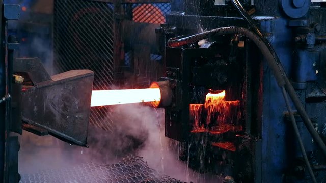 Ironworks plant. Burning Hot Billet moving through Machine