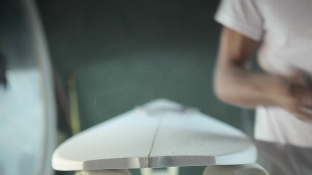 Surfboard shaping, Close up of a shaper cutting down the stringer on a surfboard