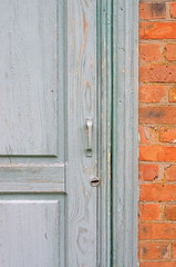 Old painted door in a brick wall