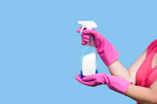 Cleaning product in the hands of the women in light blue background