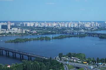 Fototapeta premium Kiev, Ukraine - 25 May 2015: Aerial view of the city buildings, Dnieper River and bridges from Monumental statue Mother Motherland