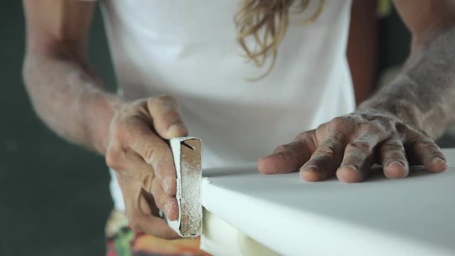 Surfboard shaping, Close up of shaper sanding the tail of the surfboard